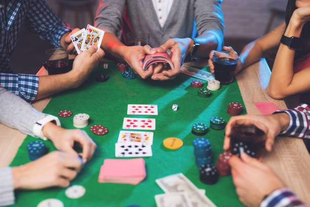 istock Young people play poker at the table. 878728424
