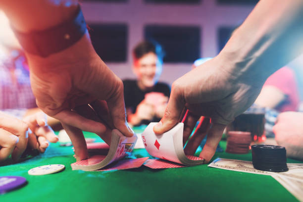 Young people play poker at the table. stock photo