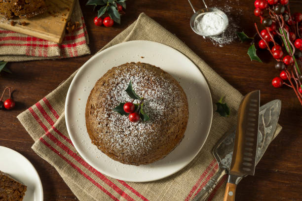 Sweet Homemade Christmas Figgy Pudding Sweet Homemade Christmas Figgy Pudding with Powdered Sugar christmas pudding stock pictures, royalty-free photos & images