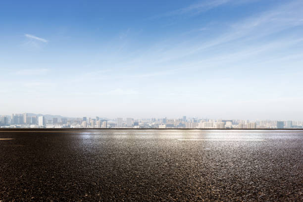 istock emtpy asphalt road with modern cityscape 878731066