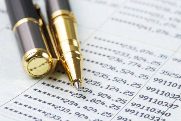 istock gold pen on bank account passbook 878733970
