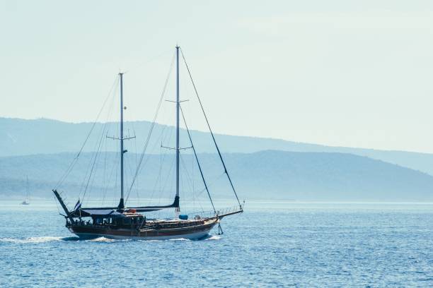 istock Sailboat on blue sea background 878734144
