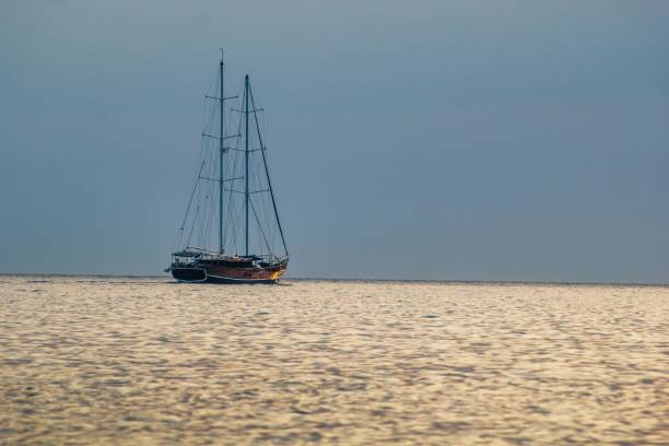 istock Sailboat on the sea at sunset 878734184