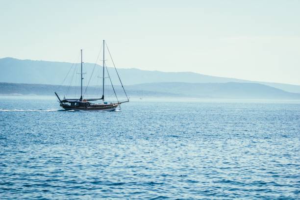 istock Sailboat on blue sea background 878734214