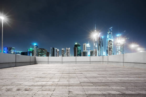 istock empty marble floor with modern buildings at night 878739572