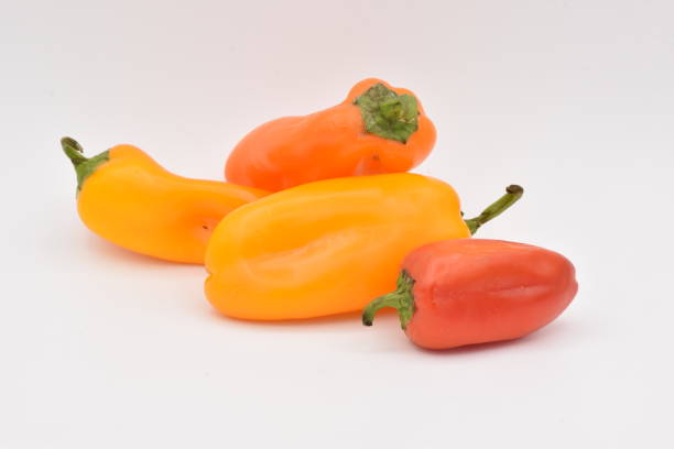 istock Yellow and Red Peppers on White Background 878740022