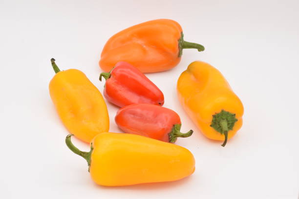 istock Yellow and Red Peppers on White Background 878740082