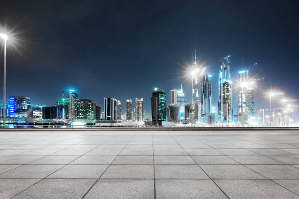 istock empty marble floor with modern buildings at night 878740098