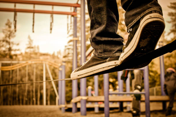 istock slack line walking in a playground 878742554