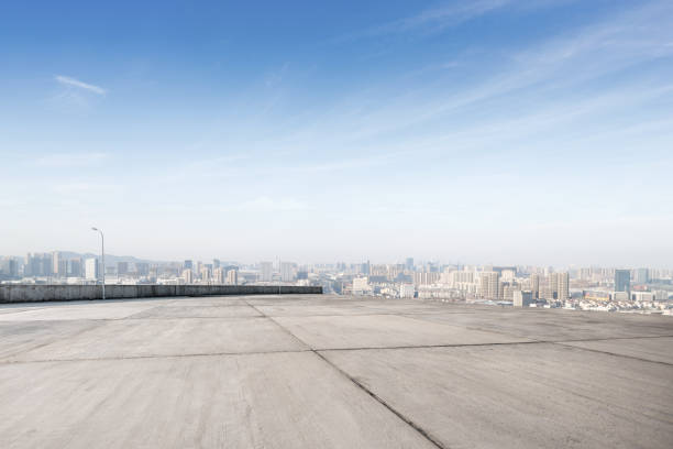 istock empty concrete floor with modern cityscape in foggy day 878745084