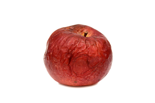 Red rotten apple on a white background, natural texture.