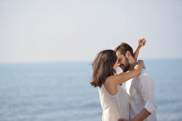 istock Romantic young couple on the beach kissing. 878756760