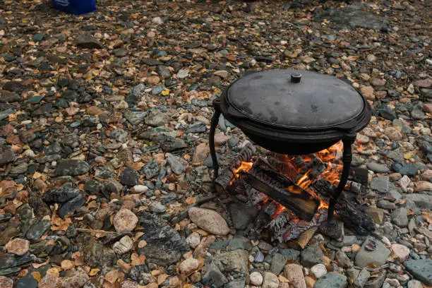 delicious fresh-soup from fish cooked in the metal pot at outdoors