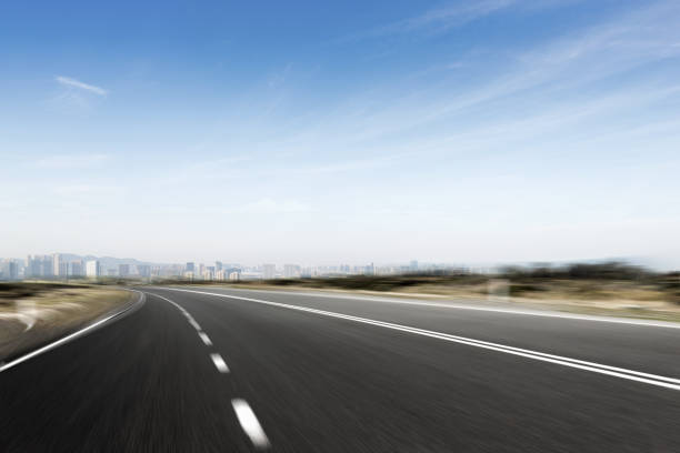 istock empty asphalt road with modern cityscape in foggy day 878768708