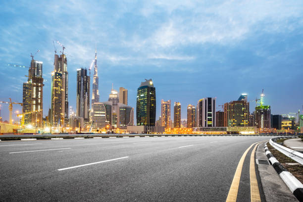 istock empty asphalt road with modern buildings at twilight 878769458