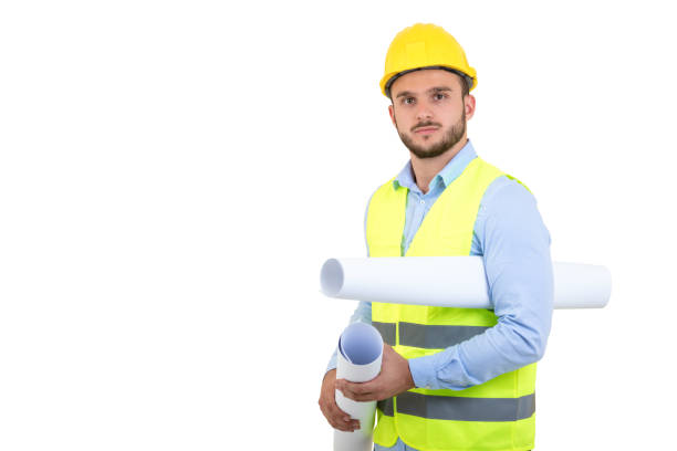 istock Young Engineer portrait holding blueprints isolated on white 878776240