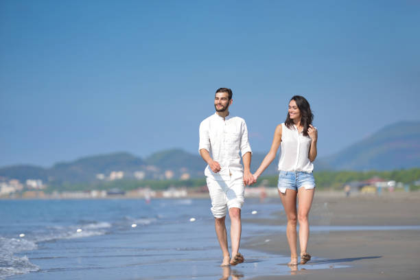 istock Young happy couple on white beach at summer vacation 878778916
