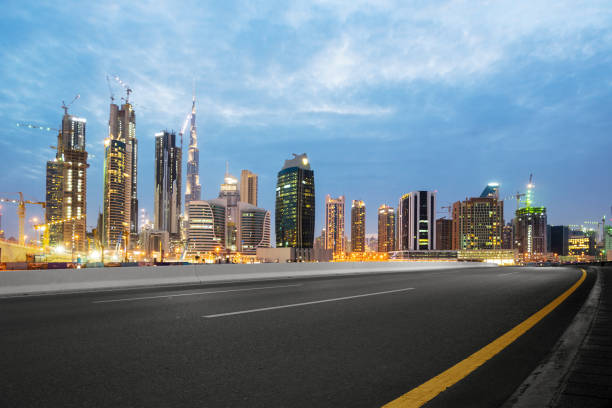 istock empty asphalt road with modern buildings at twilight 878779064
