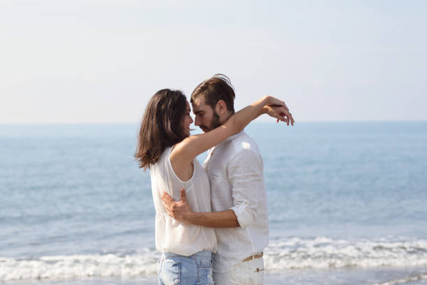 istock Romantic young couple on the beach kissing. 878779222