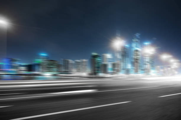 istock empty asphalt road with modern buildings at night 878779266