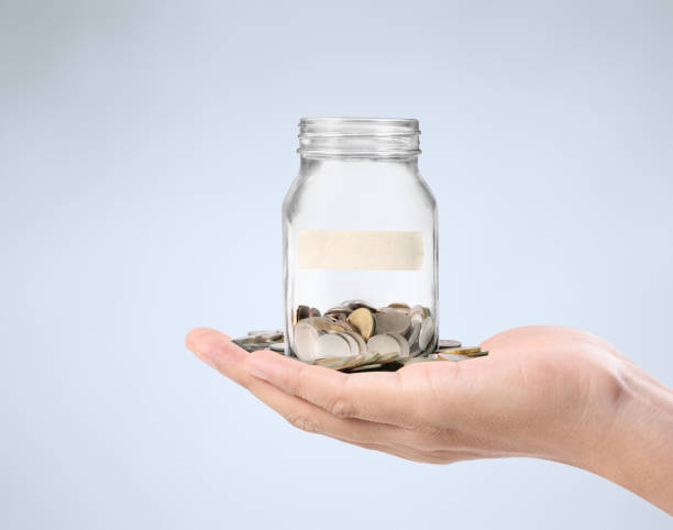 istock glass piggy  bank from  hand 878781318
