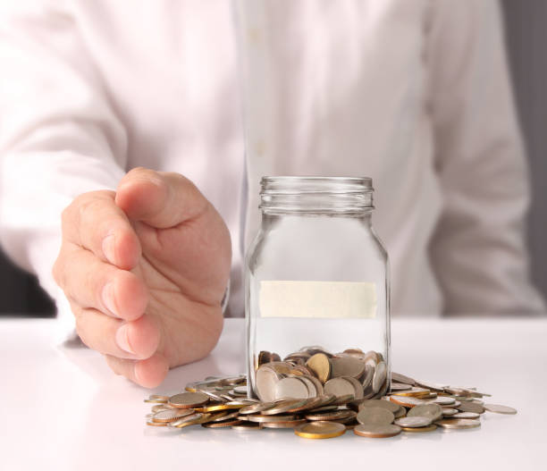 istock glass piggy  bank from  hand 878781332