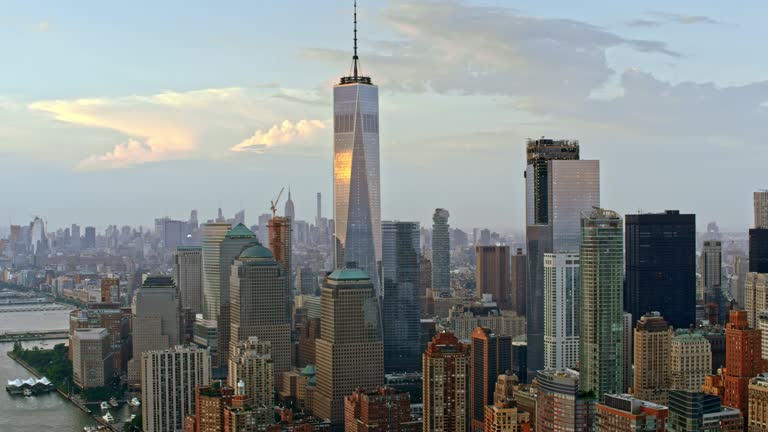 Aerial shot of the Lower Manhattan and the Freedom Tower reflecting the clouds. Shot in USA.