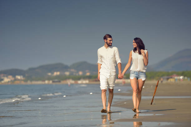 istock Young happy couple on white beach at summer vacation 878782040