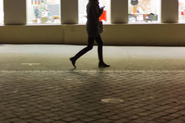 istock blurred lady walking shopping and looking smartphone 878798290