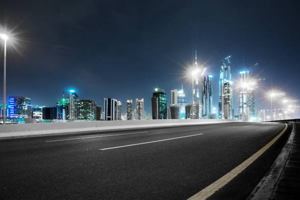 istock empty asphalt road with modern buildings at night 878800674