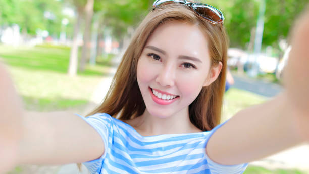 istock woman selfie happily 878800818