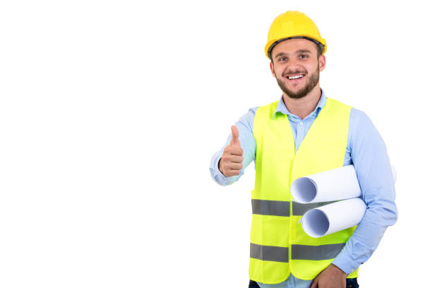 istock Young Engineer portrait holding blueprints isolated on white 878800980