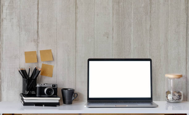 istock Modern and stylish workspace with laptop computer, office supplies, books, retro camera at home or studio. Mock up desk Concept. 878803542