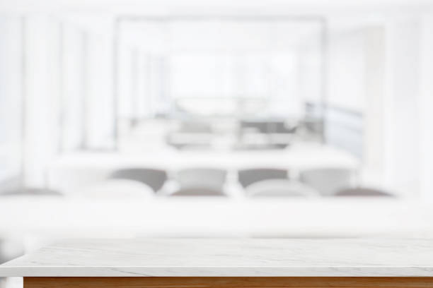 istock White marble table top and blur living room interior background. 878803578