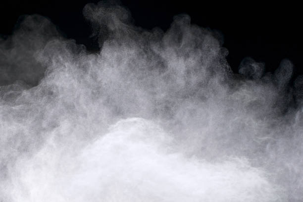 freeze motion of white powder explosions isolated on black background. - colors color image exploding fog imagens e fotografias de stock