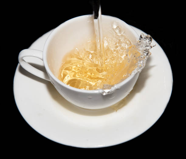 istock tea saucer with splashes on a black background 878819948