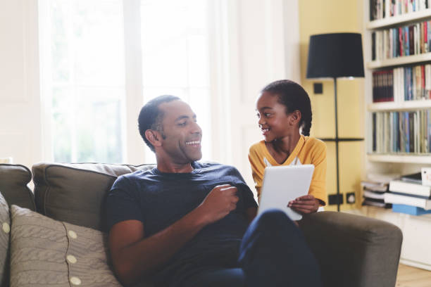istock Cheerful father and daughter with digital tablet 878830608