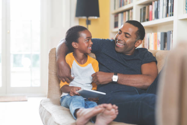 istock Smiling father and daughter with digital tablet 878830946