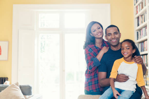 istock Happy family against window at home 878837352