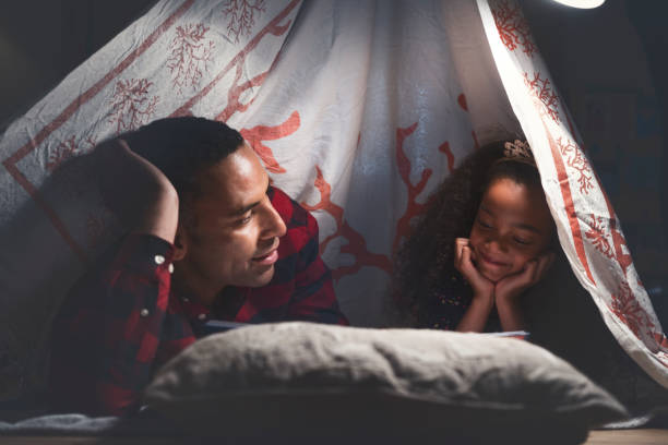 istock Father and daughter camping at home 878840798