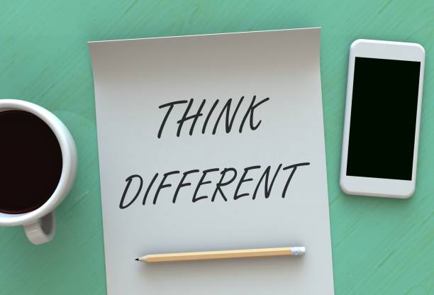 istock Think Different, message on paper, smart phone and coffee on table 878851856