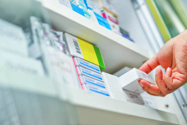 istock pharmacist hand holding medicine box 878852608