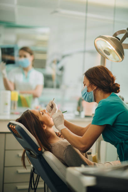 istock Young woman on dental exam at dentist's office. 878855152