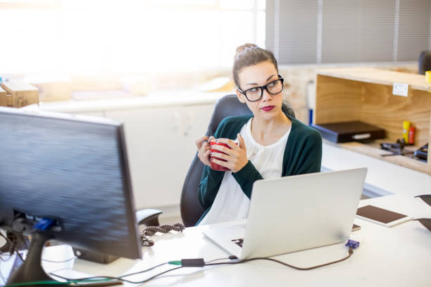 istock Businesswoman with coffee cup looking away 878855586