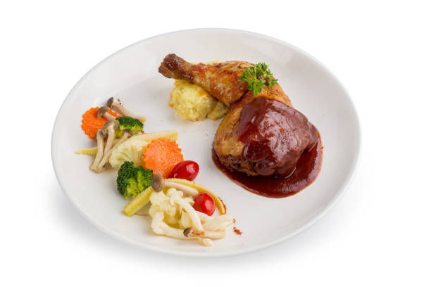 istock Grilled chicken legs and vegetables in white dish isolated on white background 878859866