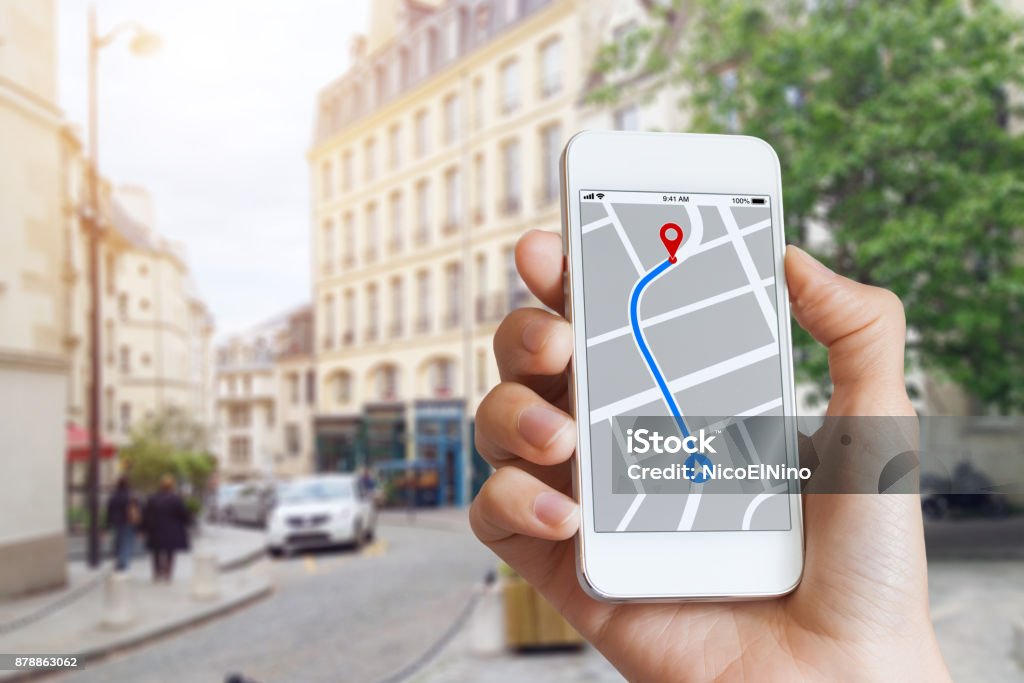 Tourist using GPS map navigation app on smartphone screen, direction Tourist using GPS map navigation app on smartphone screen to get direction to destination address in the city streets, travel and technology Global Positioning System Stock Photo
