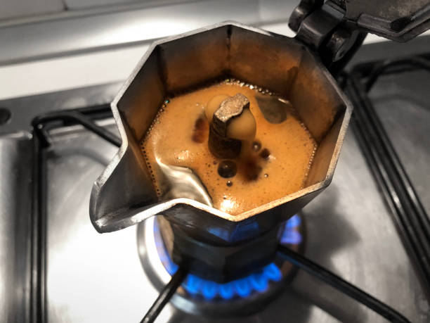 Moka with coffee on the stove top. Traditional italian coffee maker. stock photo