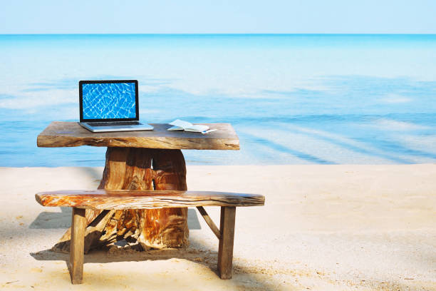 office of freelancer on the beach, freelance work concept - on beach laptop working imagens e fotografias de stock