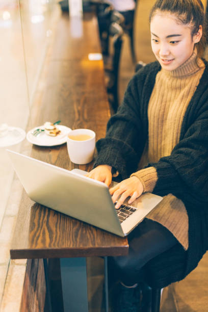 istock Young woman working with laptop in cafe 878868250