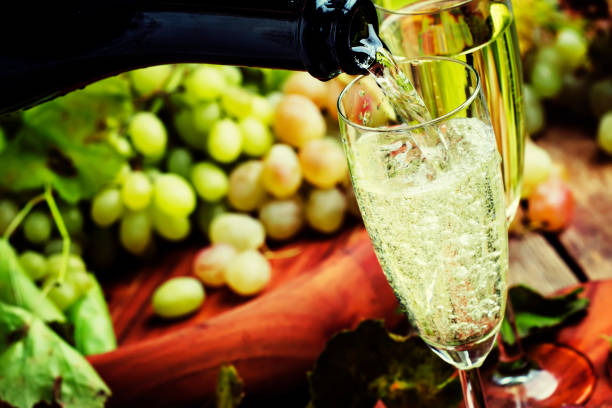 Champagne Pour In Glass, Grapes With Vine Champagne Pour In Glass, Grapes With Vine, Vintage Wood Background, Selective Focus champagne grapes stock pictures, royalty-free photos & images